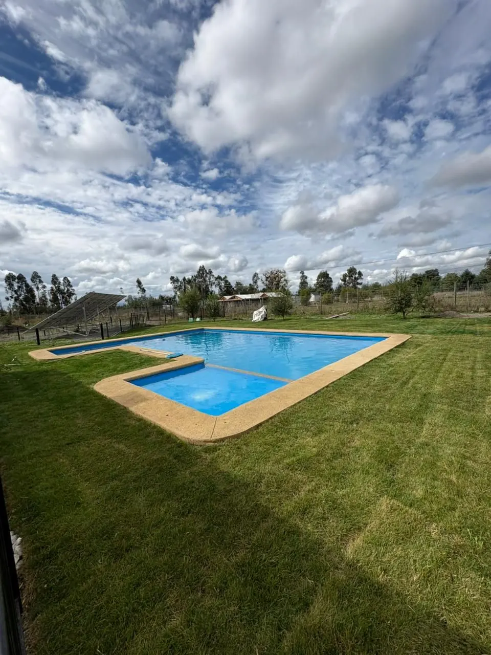 Jardín con césped instalado junto a piscina